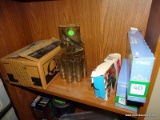 (B2) CONTENTS OF BOOK CASE. INCLUDES A MONEY MILL COIN SORTER, SOME ENVELOPES, JEWEL TONE CD STORAGE