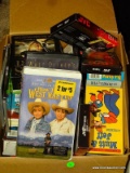 (B2CLOSET) CARDBOARD BOX FILLED WITH VHS TAPES.
