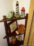 (DR) CONTENTS OF RACK. INCLUDES 2 LIGHT HOUSES AND A SHOE PLANTER, A CARVED MANGER SCENE, A HOME