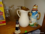 (P) RIGHT HALF OF TOP SHELF: PITCHER LOT. INCLUDES 6 PITCHERS. 1 IS SHAPED LIKE A LIGHT HOUSE, A