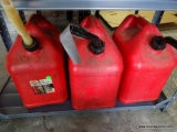 (G) SHELF LOT OF GAS CANS. INCLUDES 3 5 GAL CANS