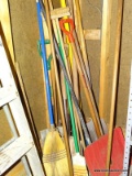 (G) CORNER LOT OF YARD TOOLS. INCLUDES BROOMS, SNOW SHOVELS, A 6FT SECTION OF COPPER PIPE, SHOVELS,