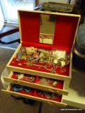 (LR) VINTAGE OFF WHITE AND RED JEWELRY BOX WITH CONTENTS. INCLUDES 2 MEN'S WATCHES, A GOLD TONE