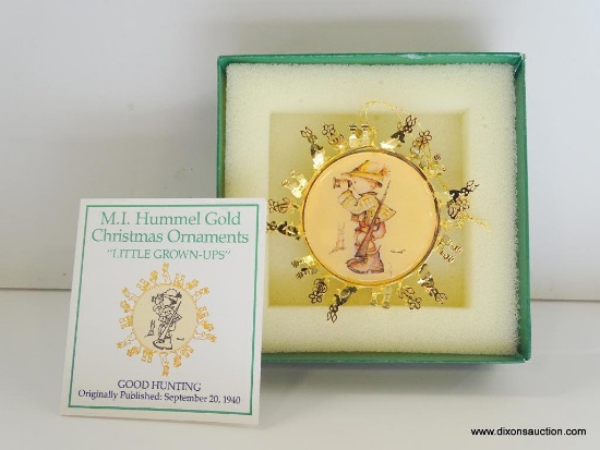 HUMMEL "LITTLE GROWN-UPS" GOLD CHRISTMAS ORNAMENT. GOOD HUNTING. 3" ACROSS. IN THE ORIGINAL BOX.