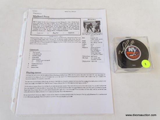 (SC) MICHAEL PECA AUTOGRAPHED TOPPS HOCKEY PUCK. HAS PROVENANCE AND IN HARD PLASTIC PROTECTIVE CASE.