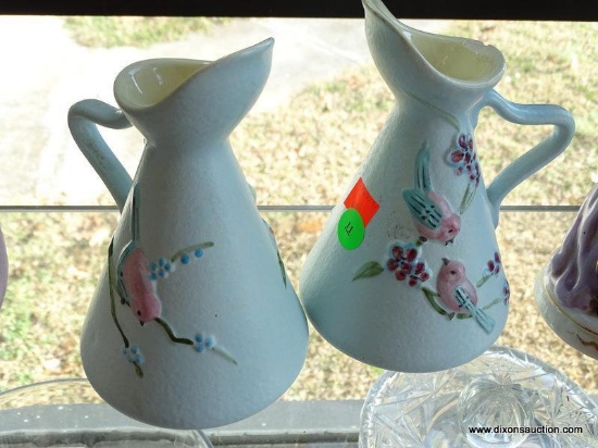 (WR) MATCHED PAIR OF BABY BLUE SIGNED HULL EWERS WITH BIRDS AND CHERRY TREES. ONE HAS A CHIP JUST