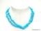 LONG STRAND OF TURQUOISE COLORED BLUE STONE CHIP BEADS. 34