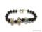 BLACK ONYX BEAD BRACELET WITH 3 ART GLASS BEADS AND TOGGLE CLASP. 8.25