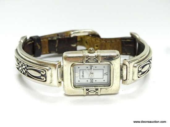 BRIGHTON MADRID LADIES WATCH. HAS A GOLD TONE HEART AT THE 12 O'CLOCK MARKER, WITH ROMAN NUMERALS AT