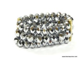 CHUNKY 3 ROW MULTI FACETED CRYSTAL BEAD EXPANSION BRACELET. SIGNED KENNETH COLE. INSIDE DIAMETER