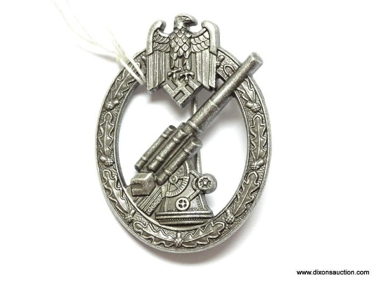 German World War II Army Flak Artillery Badge. The reverse side is maker marked "WH Wien". Has a