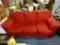 (ROW 1) RED SUEDE 3 CUSHION SOFA. IS IN VERY GOOD USED CONDITION: 89
