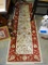 (ROW 1) ORIENTAL STYLE RUNNER IN RED AND CREAM: 25
