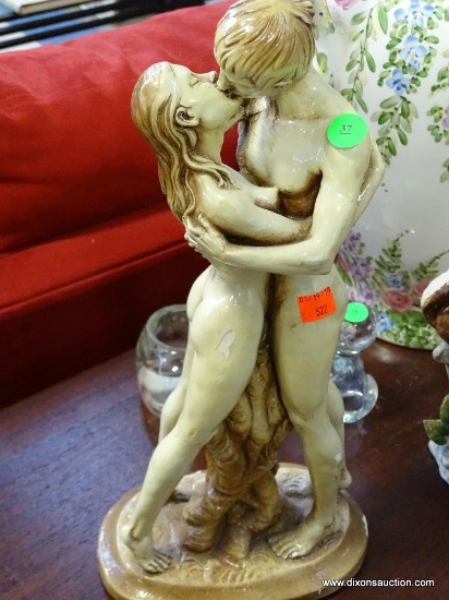 (ROW 1) COMPOSITION STATUE OF A COUPLE KISSING IN THE NUDE: 7"x15". HAS MINOR CHIPS BUT OTHERWISE IN