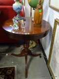 (ROW 1) CHERRY DUNCAN-PHYFE ROUND END TABLE. HAS BRASS PAW FEET: 23.5
