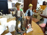 (ROW 1) 2 STATUES: 1 COMPOSITION COWBOY AND 1 CERAMIC TRUCK DRIVER DECANTER