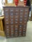 (R1) LARGE ANTIQUE OAK FILING CABINET. EACH DRAWER HAS SLOTS FOR SEPARATION. HAS 50 DRAWERS TOTAL.