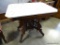 (R1) VICTORIAN EASTLAKE MAHOGANY AND MARBLE TOP TABLE. IS ON PORCELAIN CASTORS FOR EASY MOVEMENT: