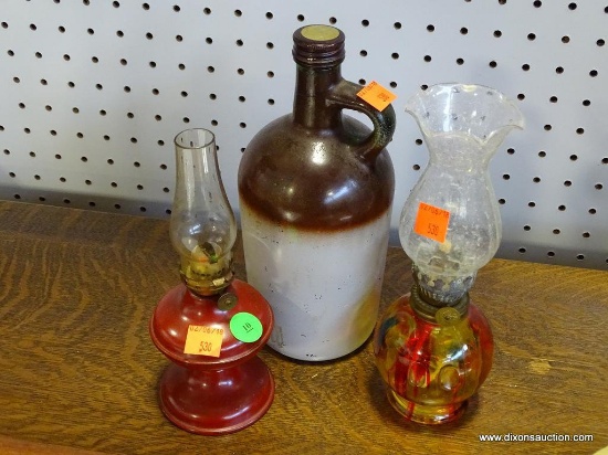 (R1) LOT OF 2 MINIATURE OIL LAMPS. 1 ART GLASS STYLE: 8" TALL. 1 IS 7" TALL. INCLUDES WHISKEY JUG