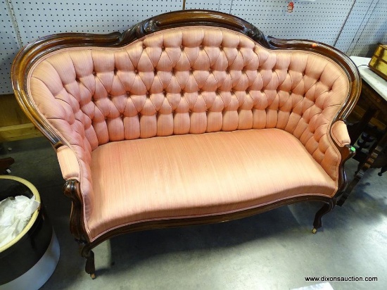 (R1) VICTORIAN WALNUT QUEEN ANNE LOVESEAT ON CASTERS. HAS BUTTON TUFTED BACK. IS IN EXCELLENT