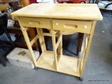 (R2) BLONDE FINISH ROLLING KITCHEN ISLAND WITH DROP SIDES. HAS 2 DRAWERS FOR STORAGE AND TOWEL BAR