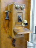 (HALL) THE COUNTRY BELLE. THIS PIECE LOOKS LIKE AN OLD WALL TELEPHONE BUT IN FACT IT IS A RADIO.