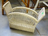 (R6) WHITE WICKER MAGAZINE RACK. MEASURES 15.5 INCHES LONG.