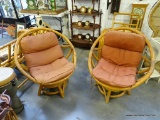(R6) PAIR OF SMALL RATTAN CHAIRS WITH CUSHIONS. THEY SWIVEL SO YOU CAN MOVE WITH THE SUN... THE