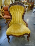 (R6) FROM THE NORVA ESTATE COMES A VICTORIAN HIP REST SLIPPER CHAIR WITH CARVED FRUIT AT THE CREST.