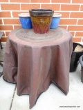 ROUND IRON TABLE WITH GLASS TOP, INCLUDE OUTDOOR COVER. LOT ALSO INCLUDES THREE PLANTERS ON TOP OF