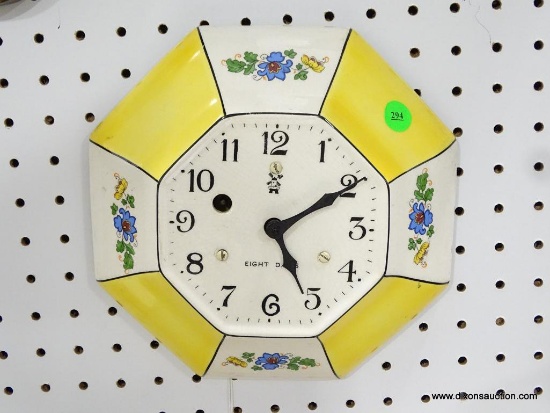 GERMAN YELLOW AND WHITE PLATE CLOCK WITH 8-DAY TIME. MEASURES 9"T X 9"W RETAIL PRICE $195