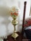 (2ND FLR MASTER BR) VINTAGE BRASS BANQUET LAMP CONVERTED TO ELECTRIC WITH PAW FEET, FLORAL PAINTED