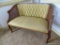 (DR) BOW LEGGED, UPHOLSTERED, AND CANE SIDED SETTEE: 44