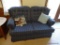 (LR) BLUE UPHOLSTERED LOVESEAT WITH 2 DECORATIVE PILLOWS. IN EXCELLENT CONDITION AND READY FOR A NEW