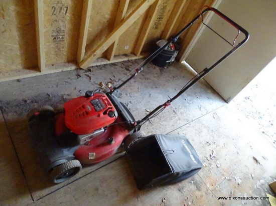 (SHED) TROY BILT PUSH MOWER WITH BAGGER ATTACHMENT. HAS A BRIGGS AND STRATTON ENGINE: 22"x58"x41"