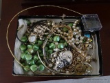 (2ND FLR MASTER BR) SMALL BOX FILLED WITH COSTUME JEWELRY: NECKLACES. BROOCHES. CLIP ON EARRINGS.