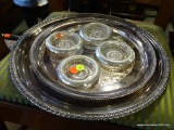 (A3) 2 ROUND SILVER-PLATE TRAYS AND 4 STERLING BANDED COASTERS.