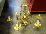 (A4) BRASS 6 LIGHT CHANDELIER . JUST NEEDS BULBS. WAITING TO BE HUNG IN THE COMFORT OF IT'S NEW