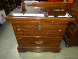 (A5) PINE 2 DRAWER END TABLE WITH GLASS PROTECTIVE TOP. DRAWERS ARE CARVED WITH WHEAT PATTERN: