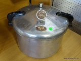 (A6) PRESTO PRESSURE COOKER-CANNER WITH LID AND PRESSURE GAUGE. INCLUDES 3 INTERIOR COOKING TRAYS.