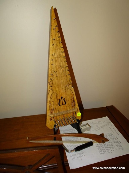 (LR) BOWED PSALTERY WITH BOW, RESIN, TUNING KEY, AND INSTRUCTIONS. ON STAND: 7"x21"