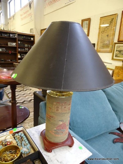 (FURNITURE ROW 1) UPHOLSTERED LAMP WITH IMAGE OF MAN PLAYING GOLF. HAS SHADE AND FINIAL: 6"x6"x24"