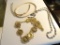 (LR) BAG LOT OF 3 COSTUME JEWELRY NECKLACES: 1 GOLD TONED NECKLACE IN THE FORM OF A SNAKE. 1 FOSSIL.