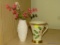 (LR) 2 PIECES OF LENOX: 1 HOLIDAY NOUVEAU CUP AND 1 VASE WITH FLOWER ARRANGEMENT.