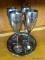 (ROW 3) LOT OF 4 SILVER PLATED CHAMPAGNE FLUTES WITH SILVER PAINTED UNDER TRAY