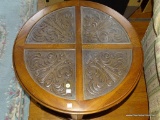 (ROW3, BACK) ROUND END TABLE WITH LOWER STORAGE CABINET AND 4 GLASS INSERTS OVER CARVED ELEGANT TOP,