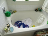 (MBTH) CONTENTS IN FRONT OF TUB: LUGGAGE CASE. FROG THEMED TUB TOYS. SOAP DISPENSER. TOWELS. AND