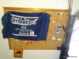 (3RD FLR) CORK BOARD WITH FOOTBALL THEMED ITEMS: STAMPS, LLOYD C. BIRD SKYHAWKS TOWEL, NY GIANTS