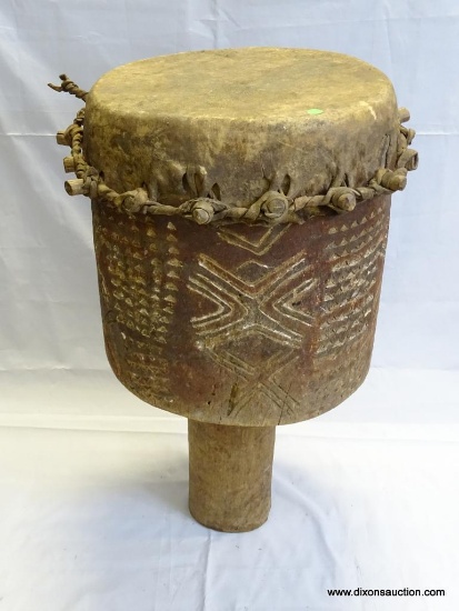 DRUM, BADIMA BUNTIBE, CIRCULAR HOLLOWED OUT HARD WOOD PEDESTAL DRUM WITH THE TOP END IMPALED WITH