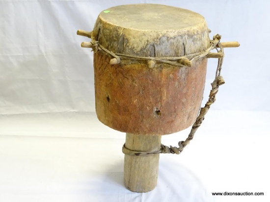 DRUM, BADIMA BUNTIBE, CIRCULAR HOLLOWED OUT HARD WOOD IMPALED WITH ANIMAL SKIN USING WOODED PEGS,